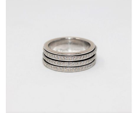 An 18ct white gold full eternity ring by Piaget, set with three bands of 157 freely rotating diamonds, the stated total diamo