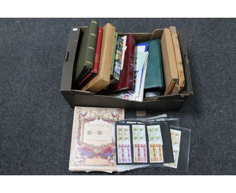 A box of a quantity of stamp albums containing a large collection of assorted stamps, first day covers 