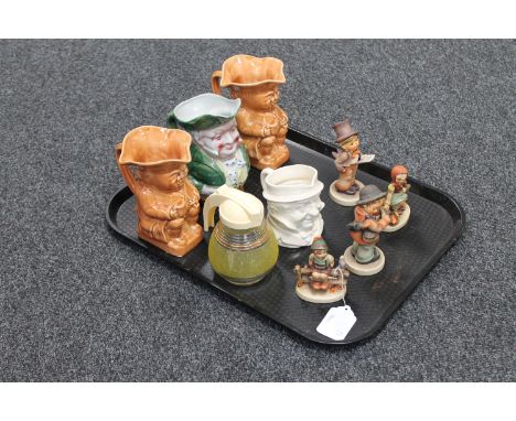 A tray of three Hummel figures, three antique Toby jugs, mid 20th century glass sugar dispenser 