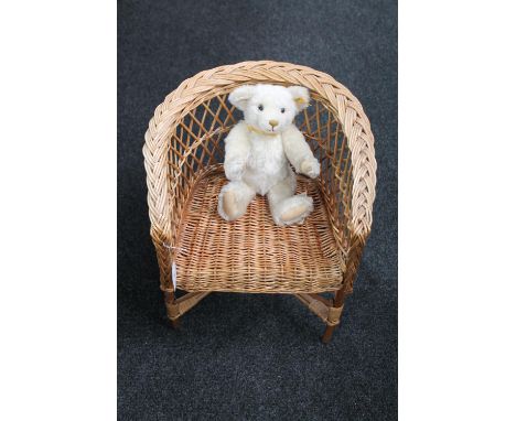 A wicker child's armchair and a Steiff Millennium mohair teddy bear  