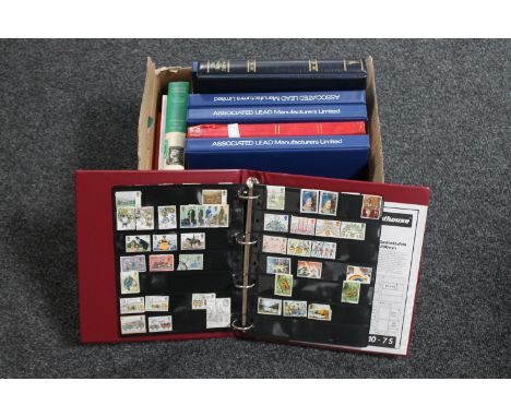 A box of seven files and an album of first day covers, two Stanley Gibbons stamp collecting books, loose stamps 