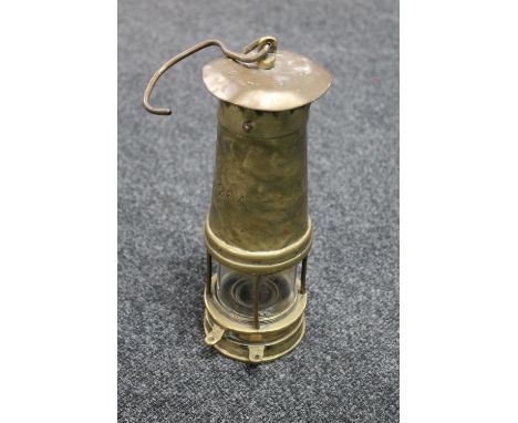 An antique brass miner's lamp numbered 1264