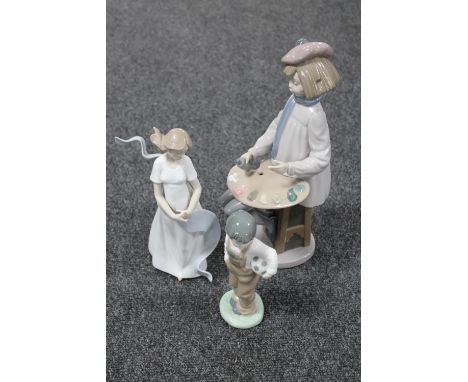 Three Nao figures : child with paints, boy with football and girl with scarf 