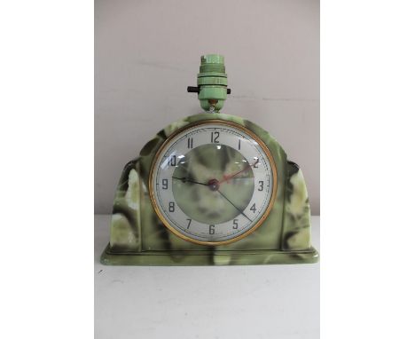 An Art Deco green Bakelite mantel clock fitted with a lamp 