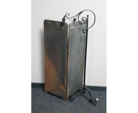 An early 20th century wrought iron adjustable floor lamp and an Art Deco two way folding screen 