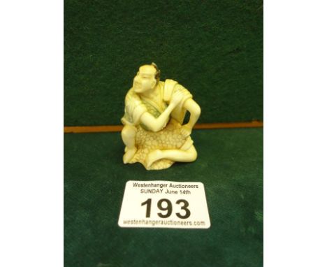 Well carved Netsuke of a seated Worrier, probably Samurai, marked to the base, 2" tall