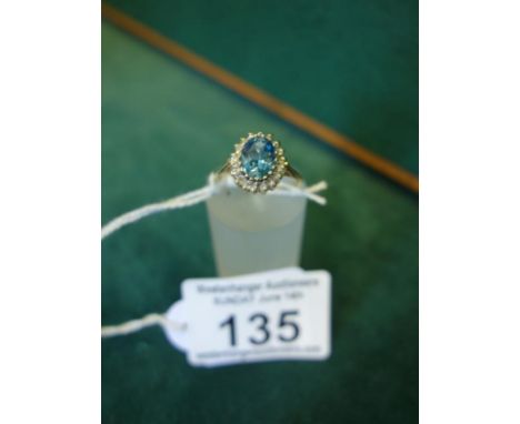 Ladies 9ct gold blue Topaz and Diamond ring, the top section set with an oval Topaz surrounded by Diamond chips, size L,