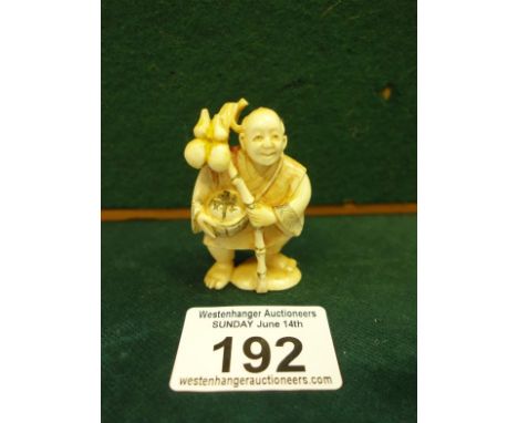 Well carved and decorated Netsuke, of a Man holding a Staff, 2" tall marked to base,