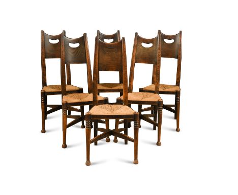 the tapering backs with pierced panels above rush-upholstered seats on ring turned tapering legs linked by bowed cross stretc