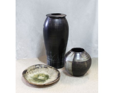 the first of bulbous cylindrical form with flared rim, 64cm high, the other of ovoid form, 30cm high, together with a a simil