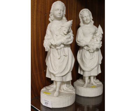 A PAIR OF VINTAGE PARIAN WARE STYLE FIGURINES OF YOUNG GIRLS HOLDING MR PUNCH PUPPETS 