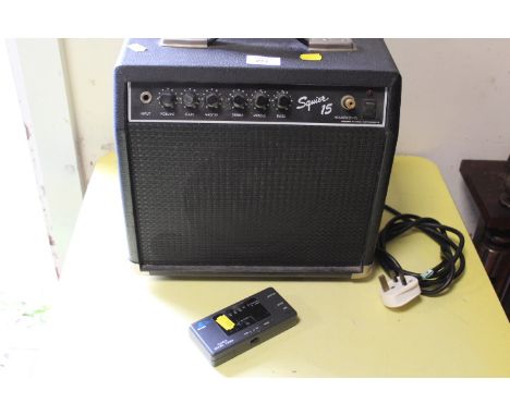 A SMALL SQUIRE 15 AMPLIFIER TOGETHER WITH A HOHNER QUARTZ DIGITAL GUITAR TUNER