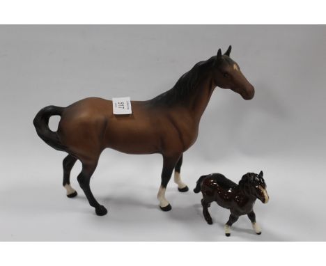 A BESWICK MODEL OF A SWISH TAIL HORSE IN MATT TOGETHER WITH A SMALL SHETLAND PONY (2)