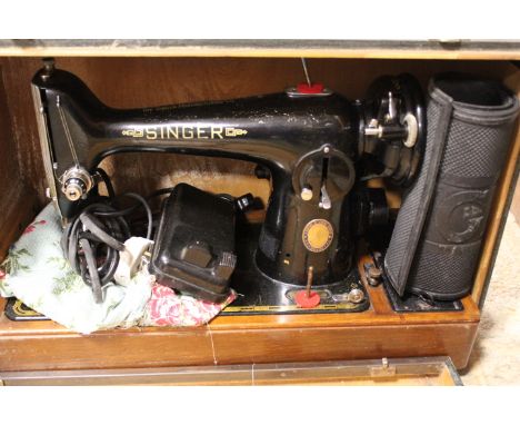A VINTAGE CASED ELECTRIC SINGER SEWING MACHINE 