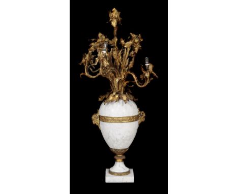 A French gilt metal mounted white marble six light table candelabrum modelled as a vase of flowers, circa 1900, with electric