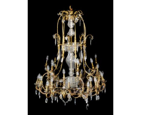 A substantial gilt bronze and glass hung thirty-five light chandelier, late 19th/ early 20th century, the openwork frame with