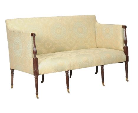 A mahogany and upholstered sofa, circa 1790 and later, the padded rectangular back and arms with fluted baluster terminal, th