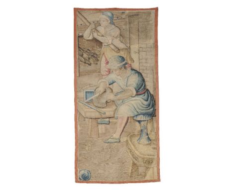 A Brussels tapestry depicting armourers at a forge, dated 1597, the central figure seated at his workbench, leaning over a he