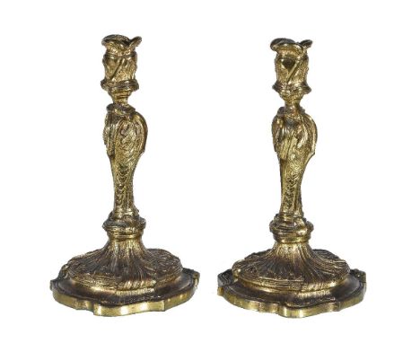 A pair of Louis XV ormolu candlesticks, in the manner of examples by the Slodtz brothers, circa 1770, both foliate and rocail