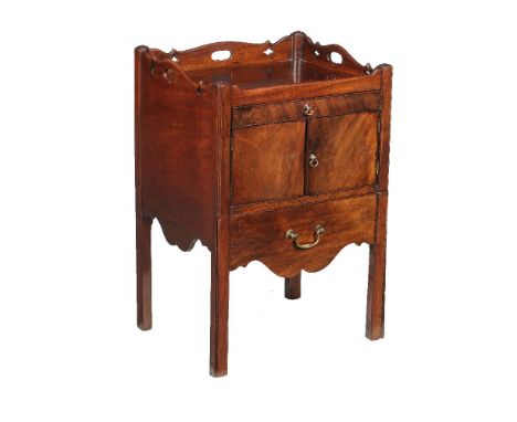 A George III mahogany tray top night commode, circa 1780, the rectangular top with shaped and pierced gallery above a shallow
