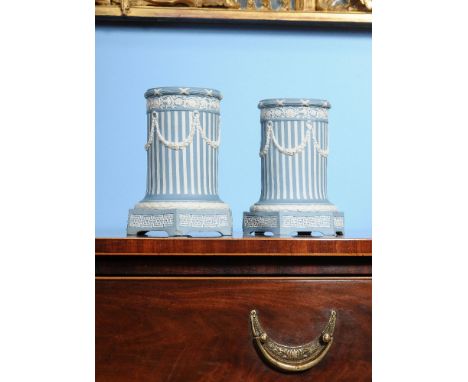 A pair of Wedgwood solid pale-blue Jasper lamp cases, circa 1790, of reeded form and sprigged in white with classical ornamen