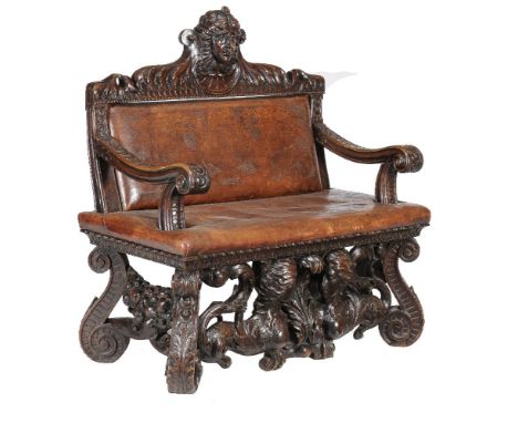 A Continental carved walnut hall bench, in Renaissance revival taste, 19th century, the  tooled leather padded back and seat 