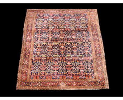 A Teftez carpet, the blue field profusely decorated with geometric floral and foliate motifs in polychrome, the red border de