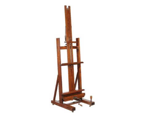 A Victorian oak artist's adjustable studio easel, by Winsor & Newton, of typical form, the crank handle turning in two apertu