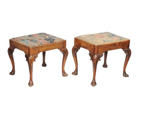 A companion pair of George II mahogany and tapestry upholstered stools, circa 1740, each tapestry drop in seat above plain fr