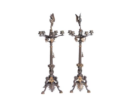 A pair of French patinated and gilt bronze five light candelabra in Neoclassical style, circa 1870, each with avine finial ab