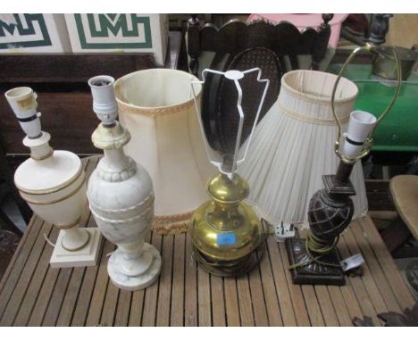 Four table lamps to include a modern bronzed example and a brass bulbous lamp, a modern mahogany and brass cased clock, surmo