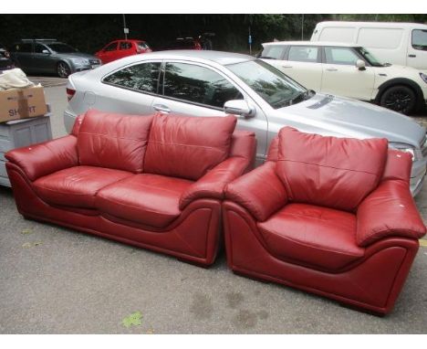 A red leather sofa and matching armchair 