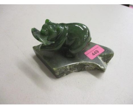 A Canadian Jade model of a polar bear with a fish A/F, mounted on a green stone plinth 