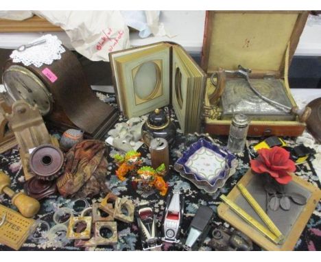 A vintage lot to include napkin rings, die cast vehicles, a small chalk board, an oak cased mantle clock, a foot warmer, a Vi
