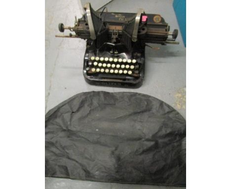 A vintage The British Oliver No.15 typewriter with dust cover 