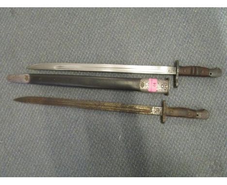 A USA Remington WW1 bayonet in a leather and metal mounted scabbard and another WW1 bayonet without a scabbard 