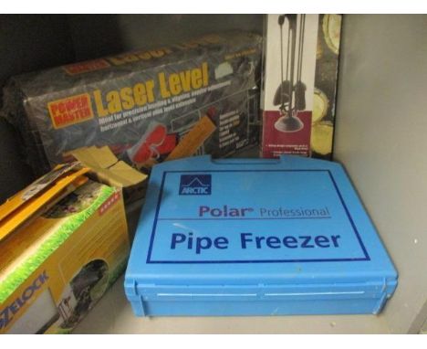 A group of boxed tools to include a lazer level, a Polar pipe freezing kit, along with a fire compendium set 