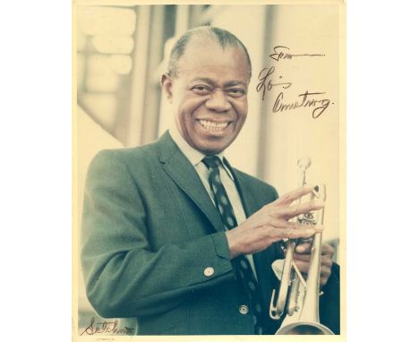 ARMSTRONG LOUIS: (1901-1971) American jazz trumpeter and vocalist. Signed colour 8 x 10 photograph of Armstrong standing in a