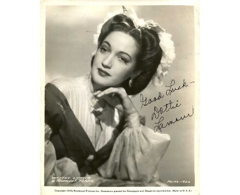 LAMOUR DOROTHY: (1914-1996) American actress. Vintage signed 8 x 10 photograph of the actress in a head and shoulders pose in