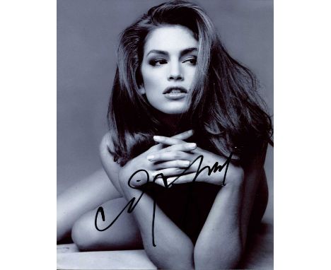 CRAWFORD CINDY: (1966- ) American Model and Actress. Attractive signed 8 x 10 photograph, the image depicting Crawford laying