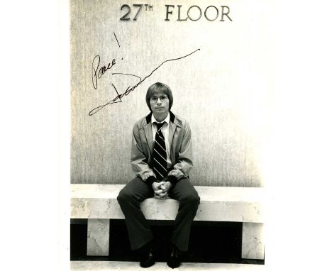 DENVER JOHN: (1943-1997) American singer and songwriter. Signed 8 x 10 photograph of Denver seated in a full-length pose, on 
