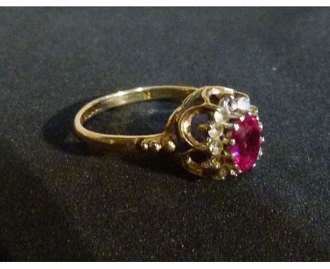 A 9ct. Gold Ring set with a central oval ruby within a pierced setting