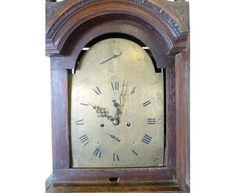 A George III Oak Longcase Clock the arched hood with reeded pilasters and three brass finials above an arched carved door and