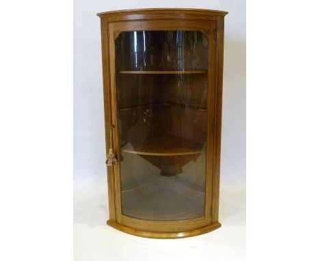 A Barnsley Workshop Bow Fronted Hanging Corner Cabinet, line inlaid with a glazed door enclosing shelves complete with invoic