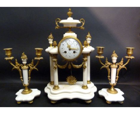 A Late 19th Early 20th Century French White Marble Gilt Metal Mounted Clock Garniture, the serpentine and portico clock with 