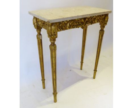 A French Gilded Console Table with a variegated marble top above a relief decorated frieze raised upon turned tapering fluted