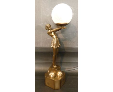 An Art Deco Style Figural Table Lamp in the form of a girl with opaque spherical glass shade, 57 cms tall