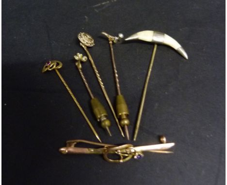 A Gold Stick Pin mounted with a Wish Bone with Diamond and Pearl, together with four other stick pins and a gold bar brooch