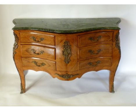 A Large French Walnut and Gilt Metal Mounted Bombe Commode, the variegated marble top above six drawers with scroll handles r
