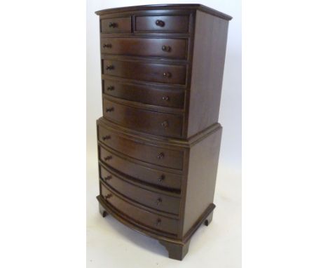 A Miniature Bow Fronted Collectors' Chest on Chest with two short and eight long drawers with knob handles raised upon bracke